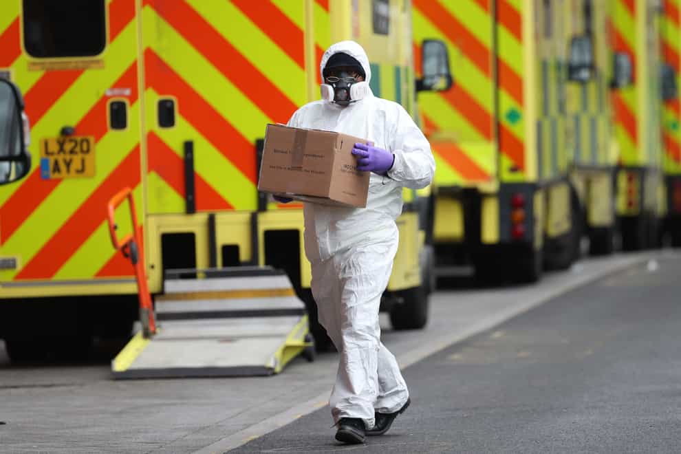 A man wearing PPE makes a delivery to the Royal London Hospital