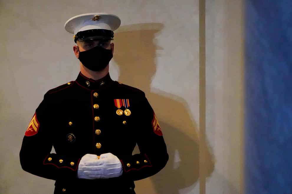 A Marine stands guard at the entrance of the West Wing of the White House, on President Donald Trump’s last day in office (Gerald Herbert/AP)