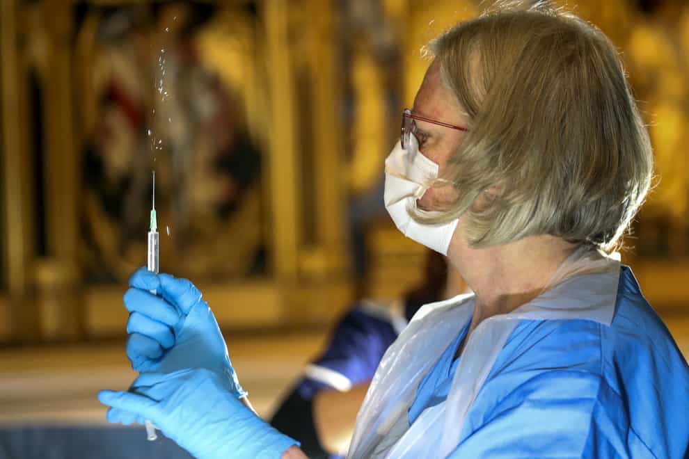 The Pfizer coronavirus vaccine is prepared by a health worker at Salisbury Cathedral (Steve Parsons/PA)
