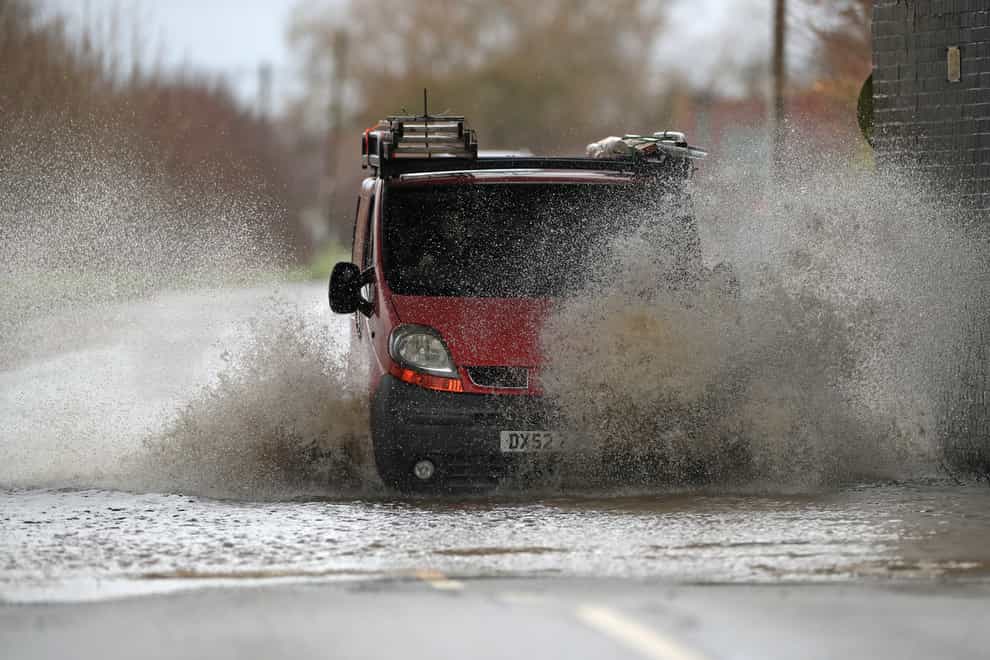 A van is driven through floodwater in Sedgebrook, Lincolnshire (Mike Egerton/PA)
