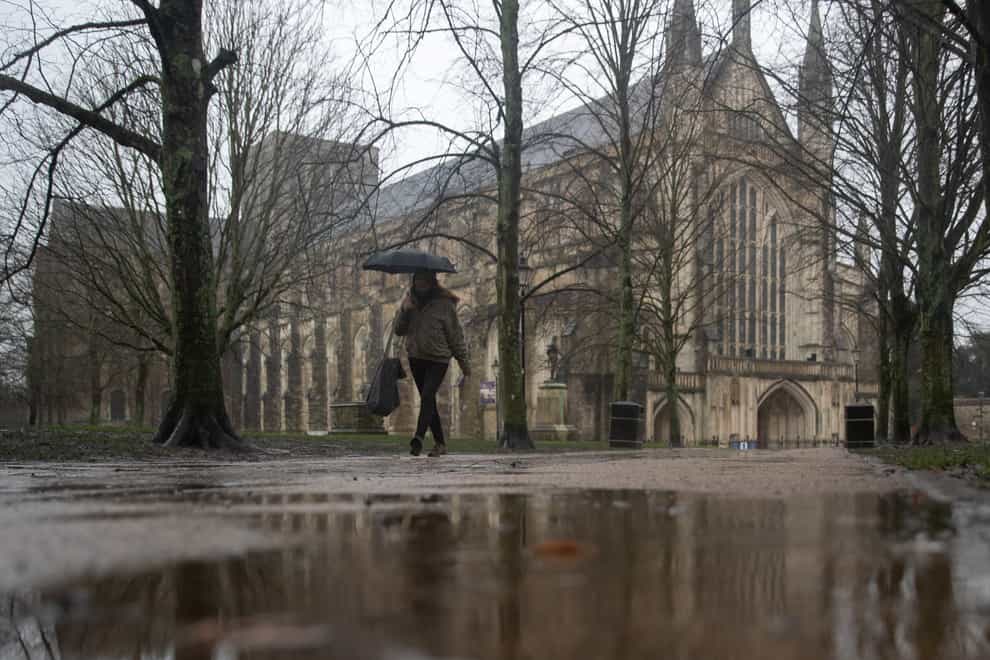 A person walks through the grounds of Winchester Cathedral in Winchester, Hampshire (Andrew Matthews/PA)
