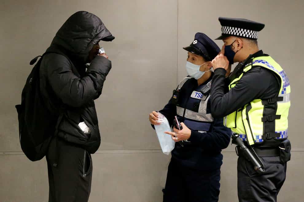 Police officers speak to a member of the public
