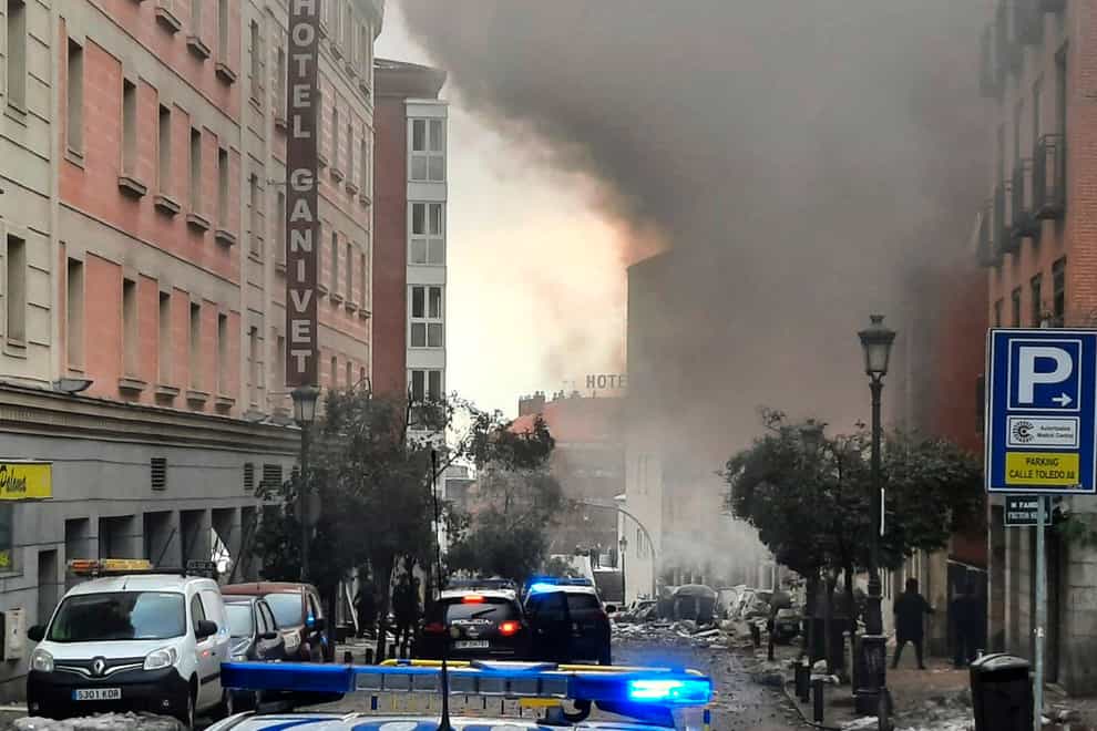 Smoke rises from a building and rubble scattered in Toledo Street following a explosion in Madrid