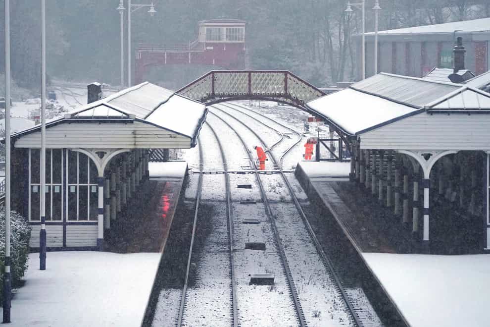 Rail workers checking the points at Hexham train station, Northumberland