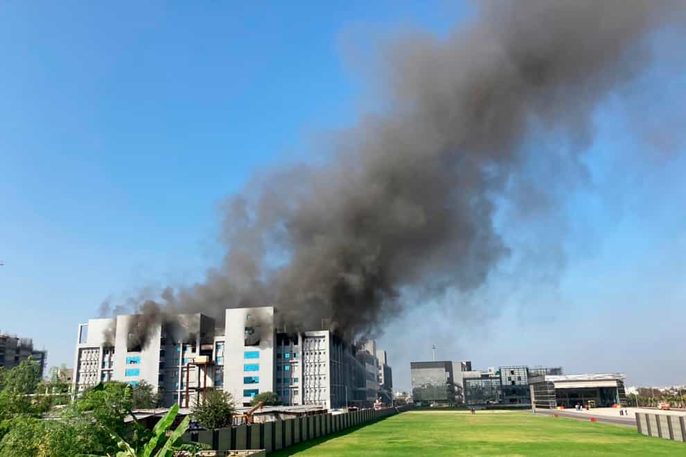 Smoke rises from the Serum Institute of India, the world’s largest vaccine maker that is manufacturing the AstraZeneca/Oxford University vaccine in Pune, India