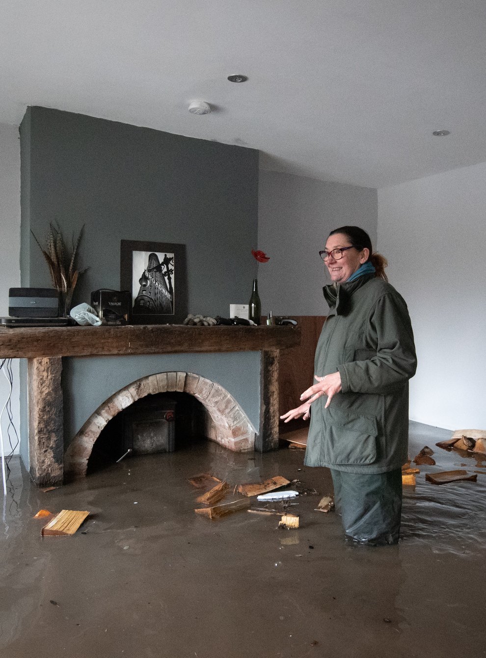 Gabrielle Burns-Smith looks out from her flooded home on the outskirts of Lymm (Joe Giddens/PA)