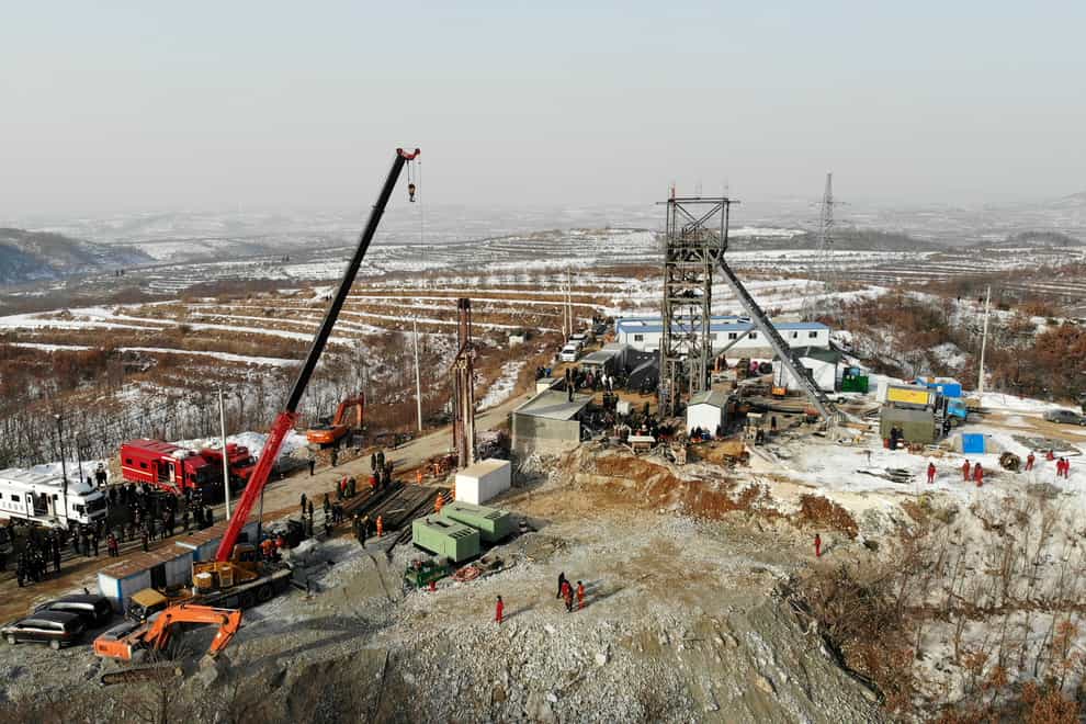 Rescuers work at the site of a gold mine that suffered an explosion in Qixia in eastern China's Shandong Province