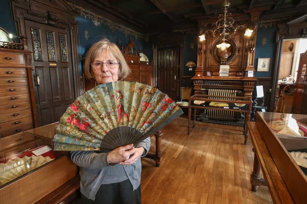 Anne Hoguet, 74, fan maker and director of the hand fan-making museum, poses with a a wood roasted hand fan representing the falcon hunt, gouache painting on paper dated from 1880 in Paris