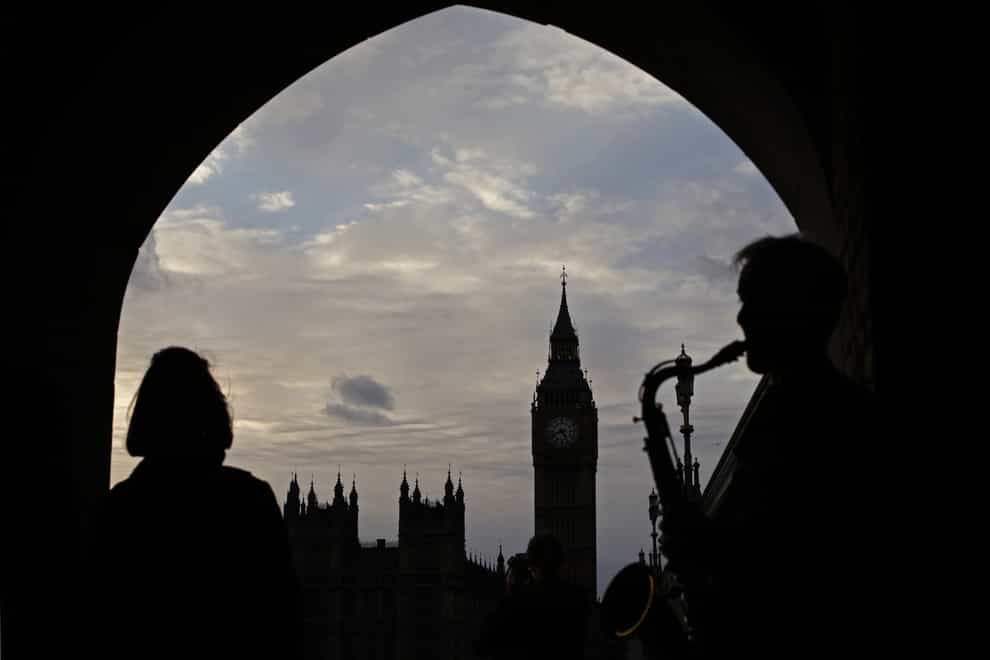 A saxophonist silhouetted in front of Big Ben and the Houses of Parliament