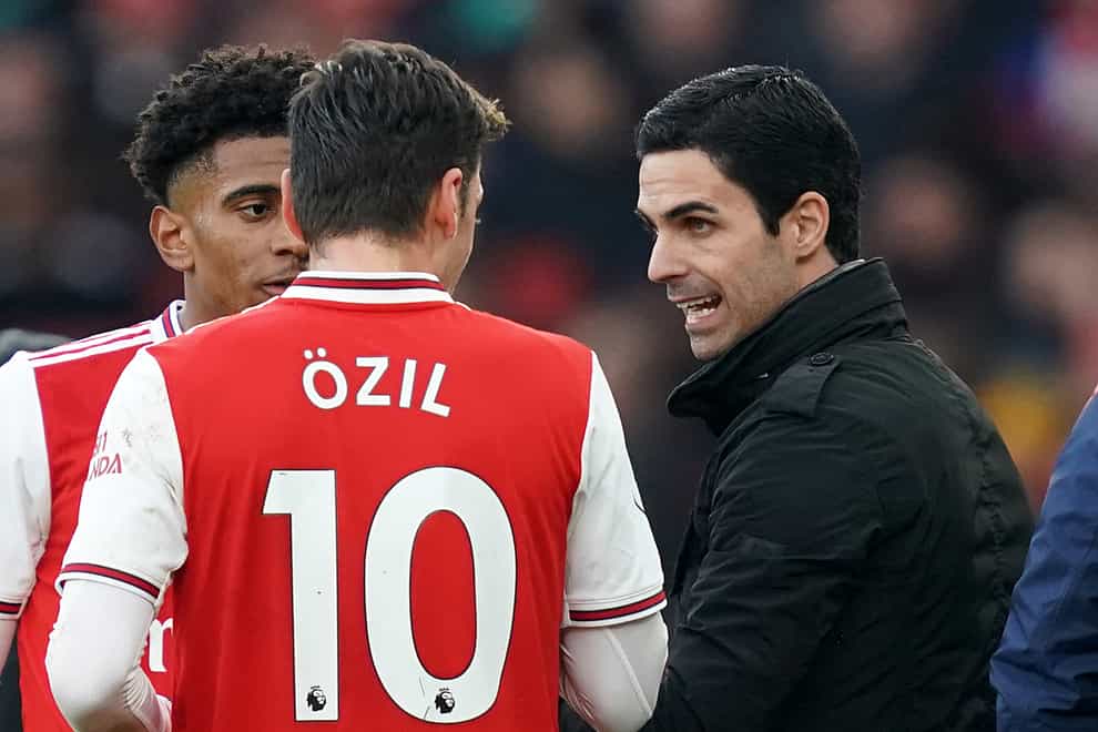 Arsenal manager Mikel Arteta, right, and Mesut Ozil