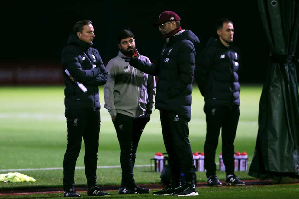 Liverpool manager Jurgen Klopp speaks with his coaching staff on the training ground
