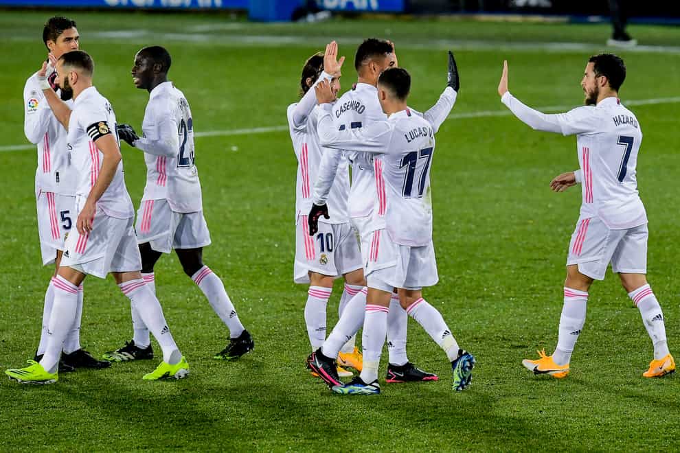 Real Madrid's players congratulate each other after a winning performance against Alaves