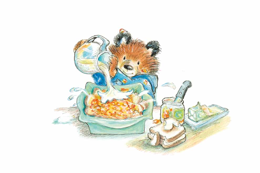 An illustration of Paddington Bear making bread and butter pudding