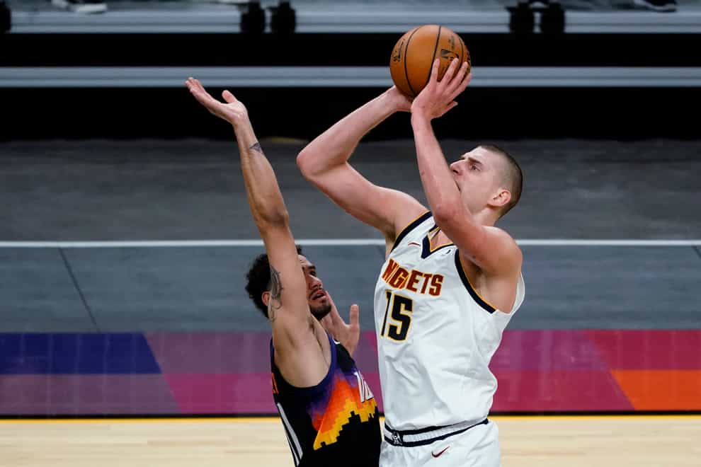 Denver Nuggets center Nikola Jokic (15) shoots over Phoenix Suns forward Abdel Nader