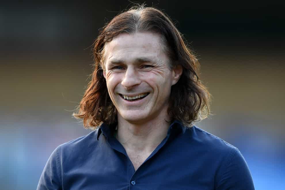 Gareth Ainsworth smiles on the touchline