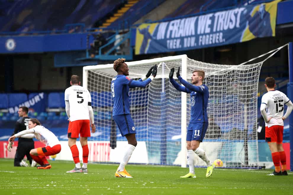 An 'In Frank we trust' banner is displayed behind the goal as Chelsea’s Tammy Abraham (centre) celebrates the first goal of his hat-trick against Luton with team-mate Timo Werner at Stamford Bridge.