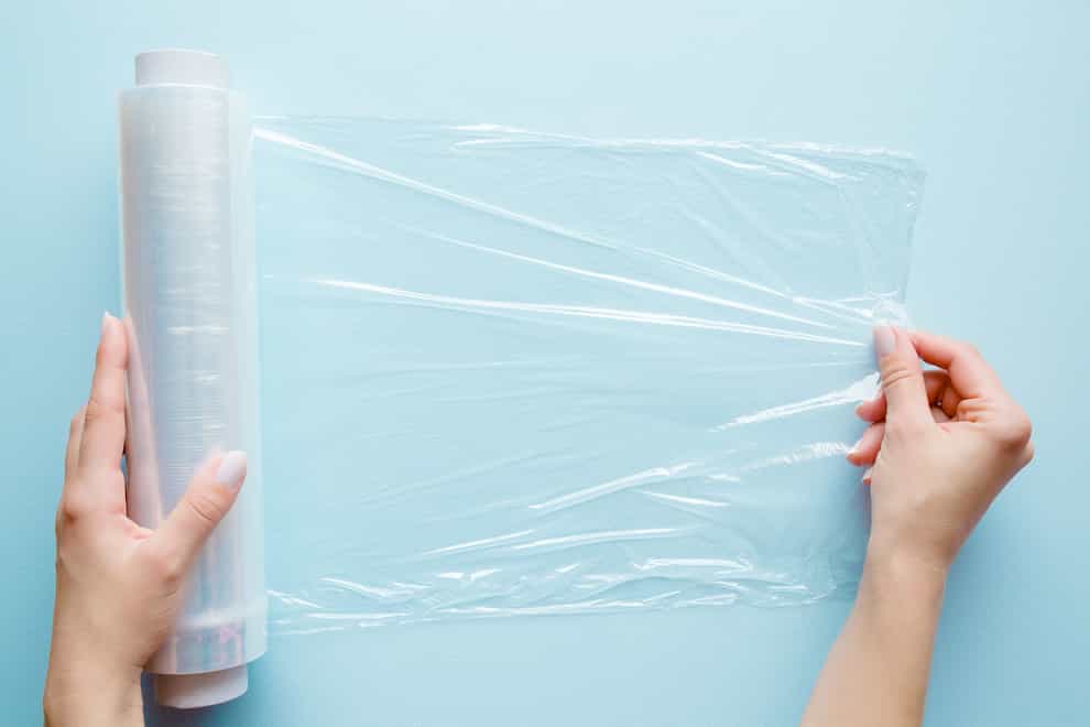Woman's hand using a roll of cling film (iStock/PA)