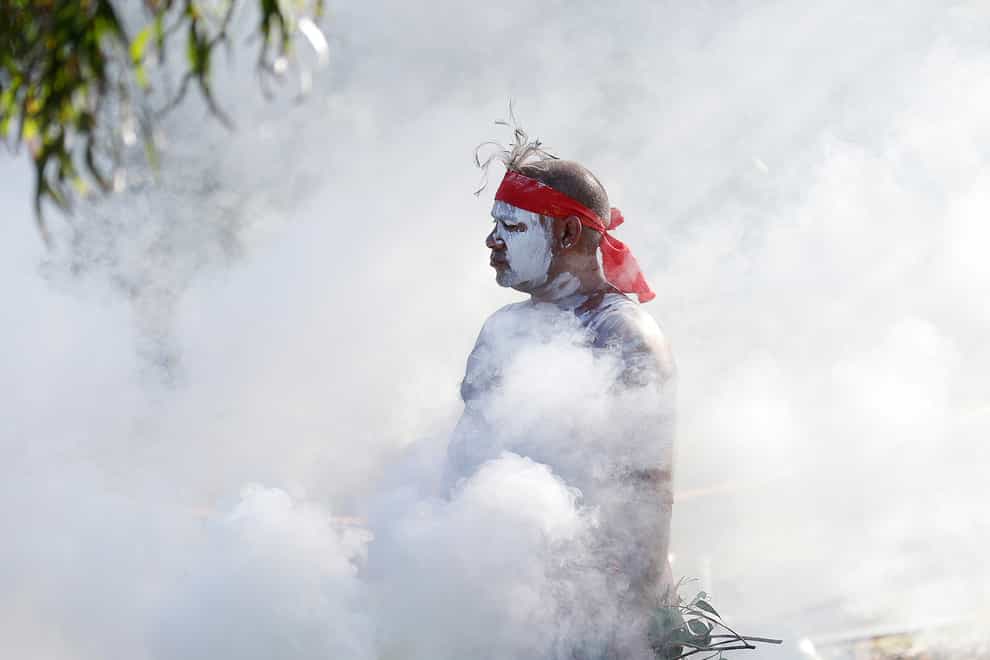 Russell Dawson of the Koomurri Aboriginal Dancers participates in a smoking ceremony during Australia Day ceremonies in Sydney