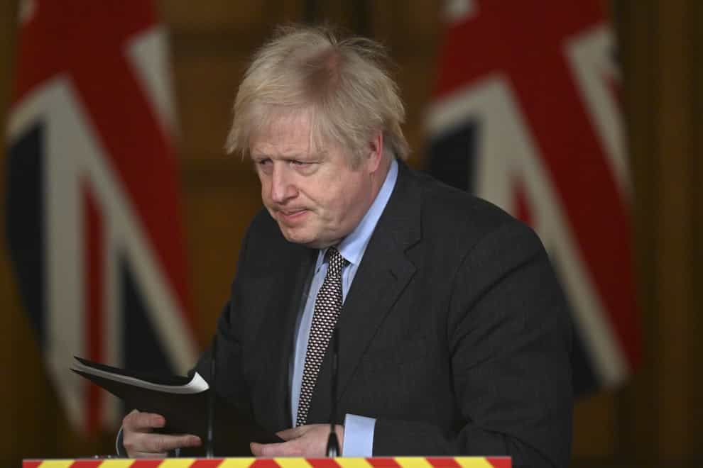 Prime Minister Boris Johnson leaves the podium following a media briefing in Downing Street on coronavirus