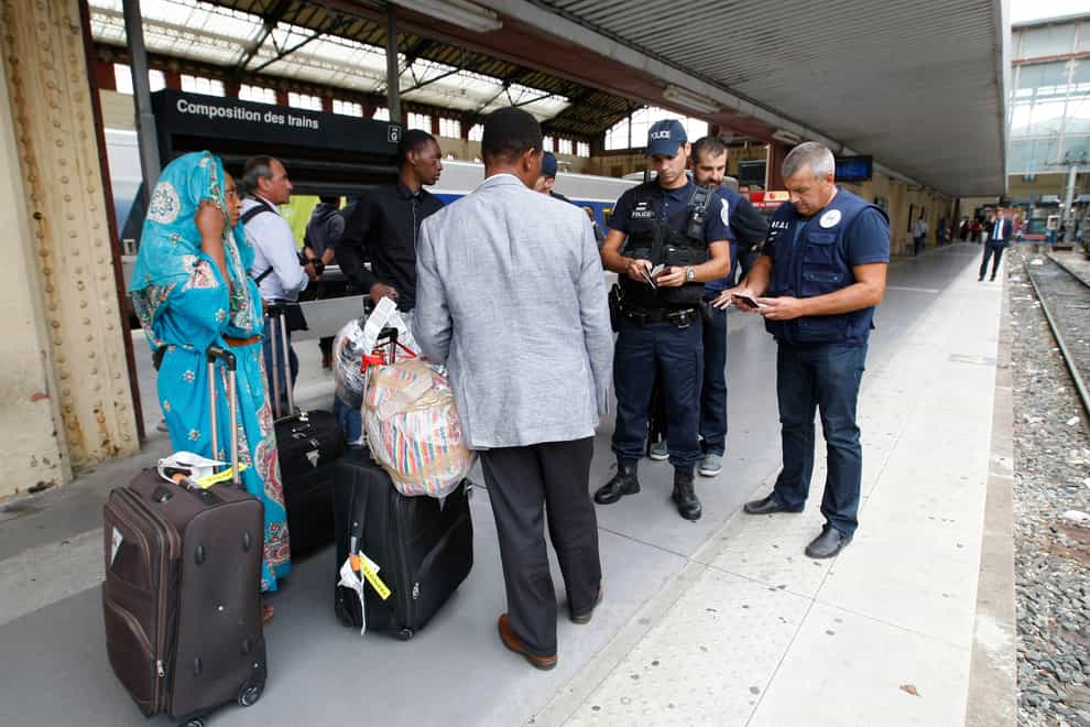 French police check identity documents at Saint-Charles station in Marseille