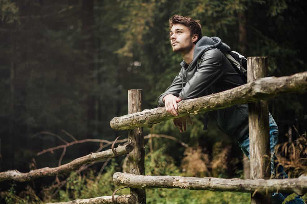 Young man with backpack hiking in the forest (iStock/PA)