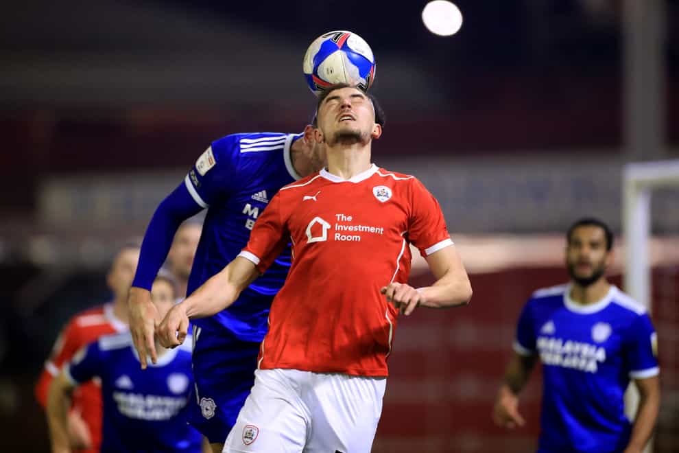 Cardiff’s Kieffer Moore and Barnsley’s Michal Helik battle for the ball