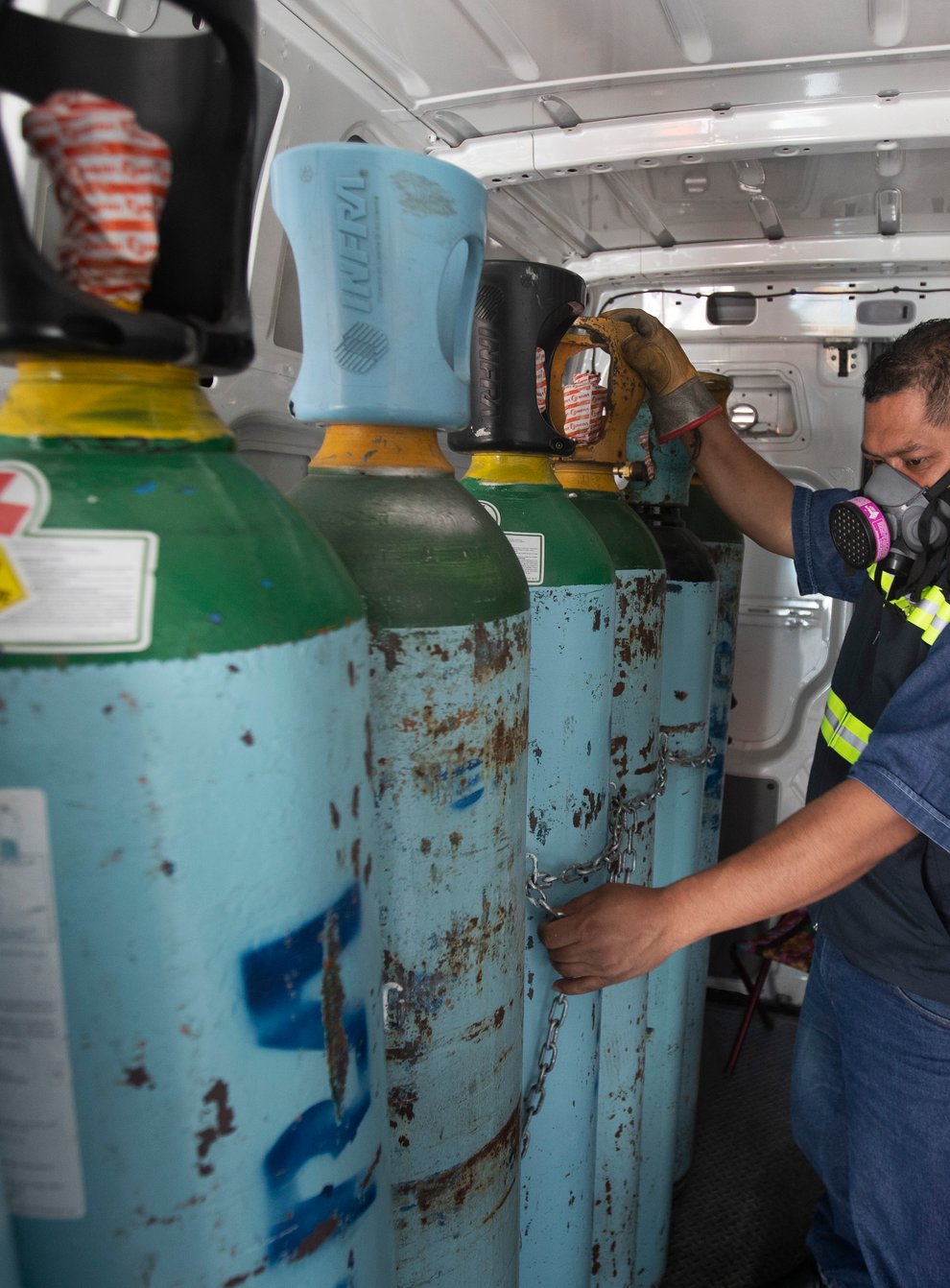 Health worker Jose Antonio Pena refills oxygen tanks for patients with Covid-19 in the Iztapalapa district of Mexico City