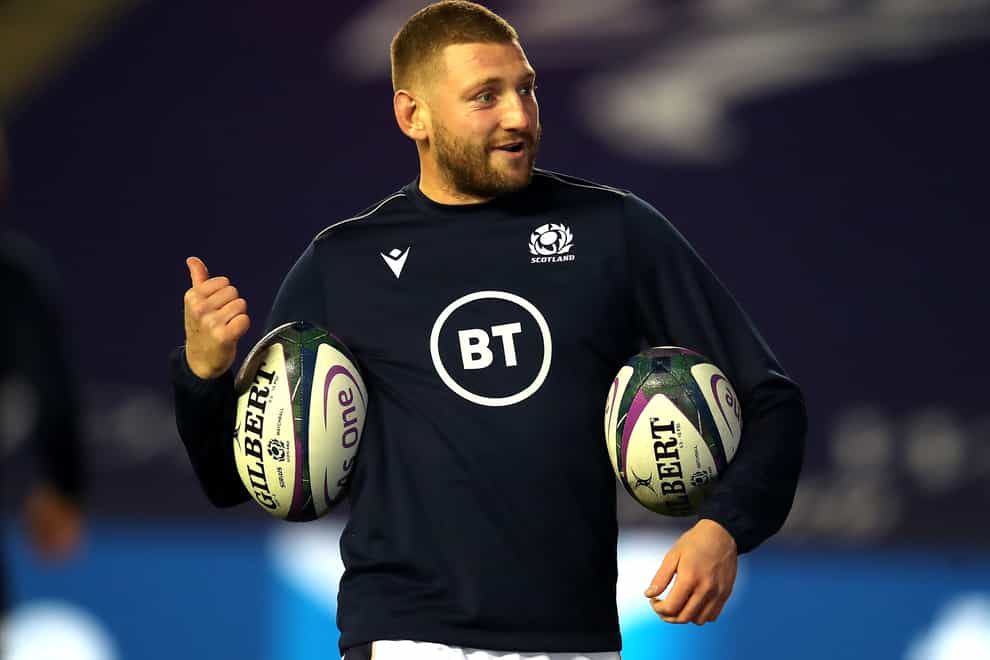Finn Russell carries two rugby balls in practice