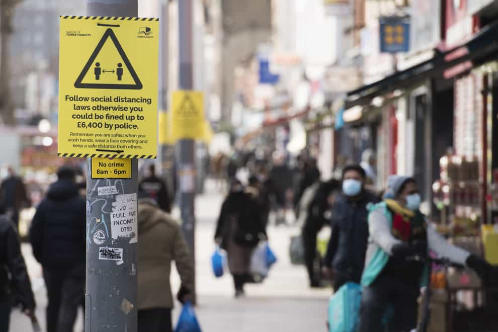 Coronavirus signs on Whitechapel Road in London