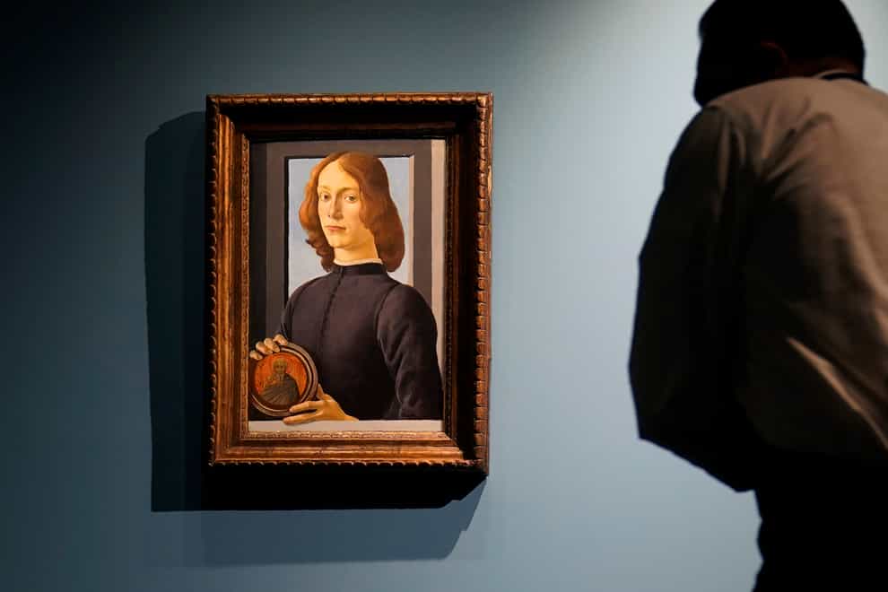 Sandro Botticelli’s painting called Young Man Holding A Roundel is displayed at Sotheby’s in New York
