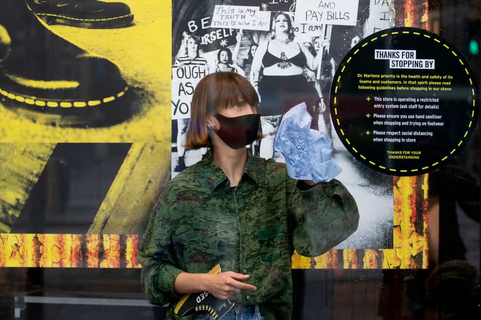 A woman in front of a Dr Martens poster