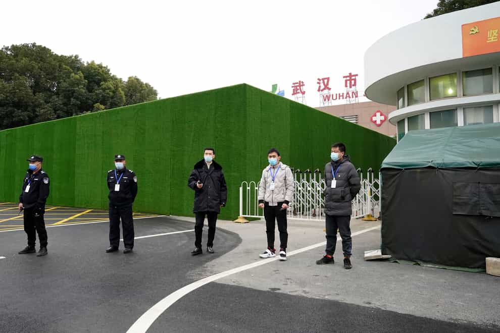 Security personnel guard an entrance to the Wuhan Jinyintan Hospital where a team from the World Health Organisation visited