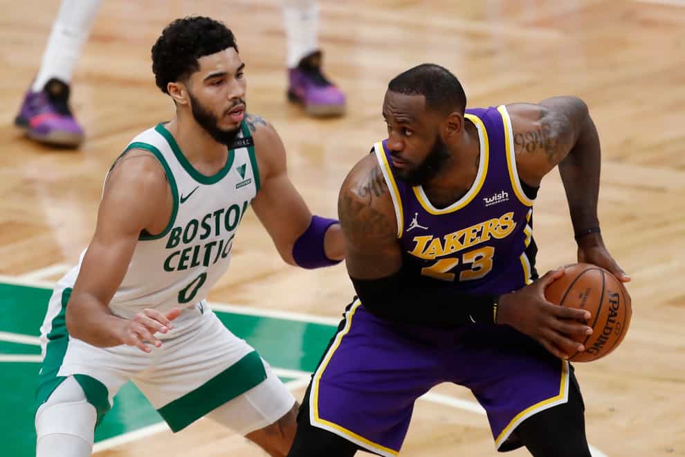 Boston Celtics’ Jayson Tatum defends against Los Angeles Lakers’ LeBron James
