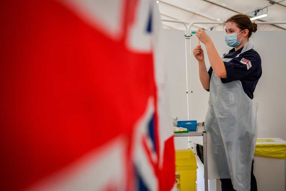 Royal Navy personnel prepare to give vaccines to the public at a coronavirus vaccination centre set up at Bath Racecourse