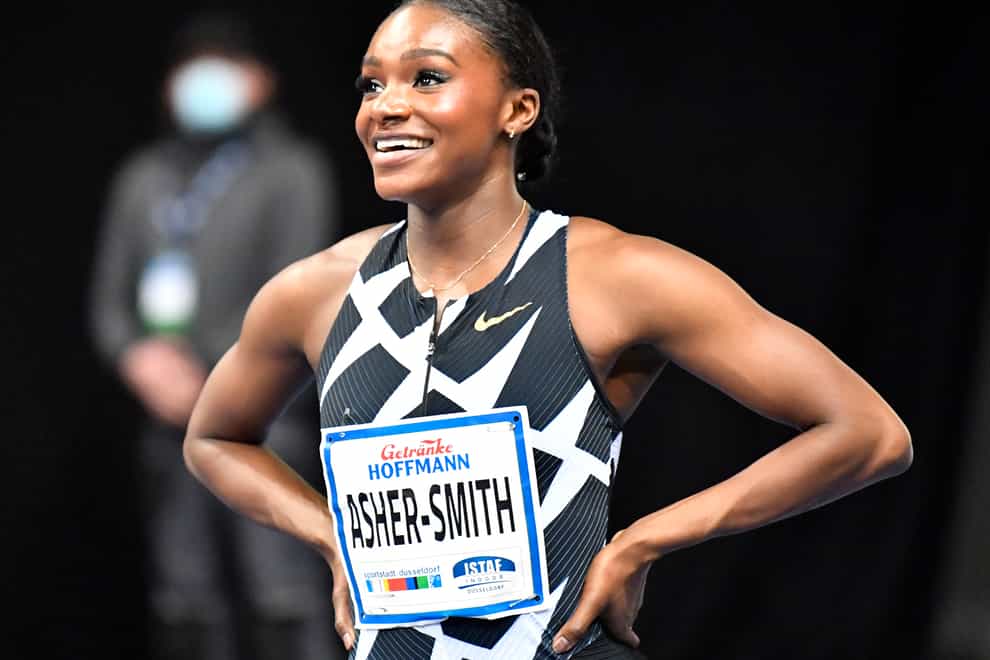 Dina Asher-Smith celebrates after winning the women’s 60 metres final