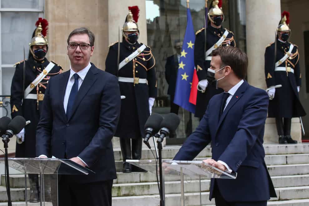 Serbian President Aleksandar Vucic , left, and French President Emmanuel Macron talk to the media (Michel Euler/PA)