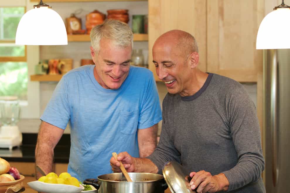 Senior Gay Male Couple Cooking Together