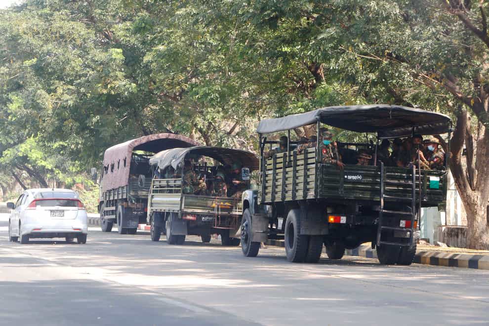 Soldiers sit inside vehicles parked on a road in Naypyitaw, Myanmar (AP)