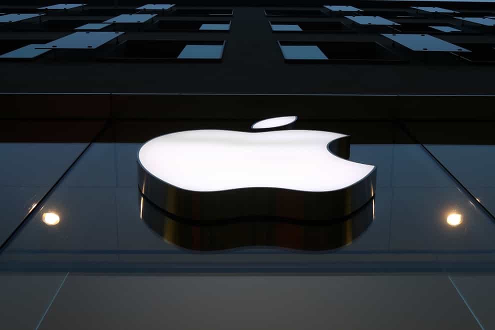 The logo of Apple is illuminated at a store in the city center in Munich (Matthias Schrader/AP)