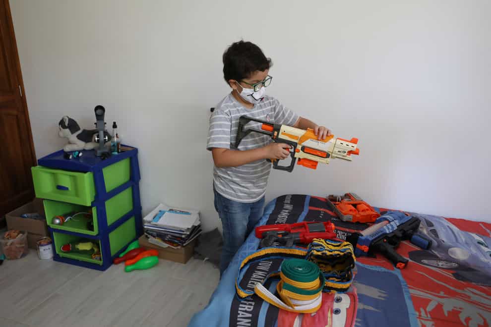 Francisco Vera, well-known in Colombia for his environmental campaigns and defence of children’s rights, plays with his toys at home in Villeta, Colombia (Fernando Vergara/AP)