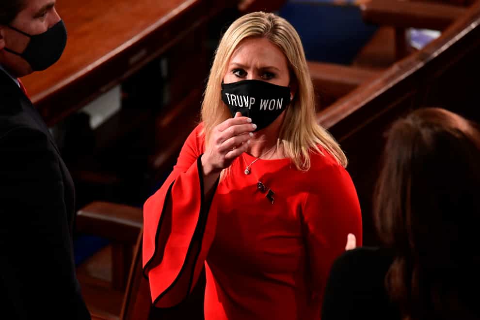 Marjorie Taylor Greene wears a “Trump Won” face mask as she arrives on the floor of the House to take her oath of office on opening day of Congress last month