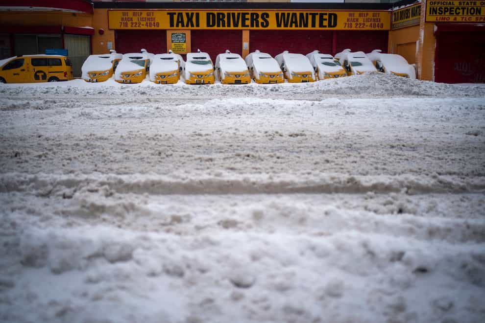 Parked taxis are covered with snow in New York