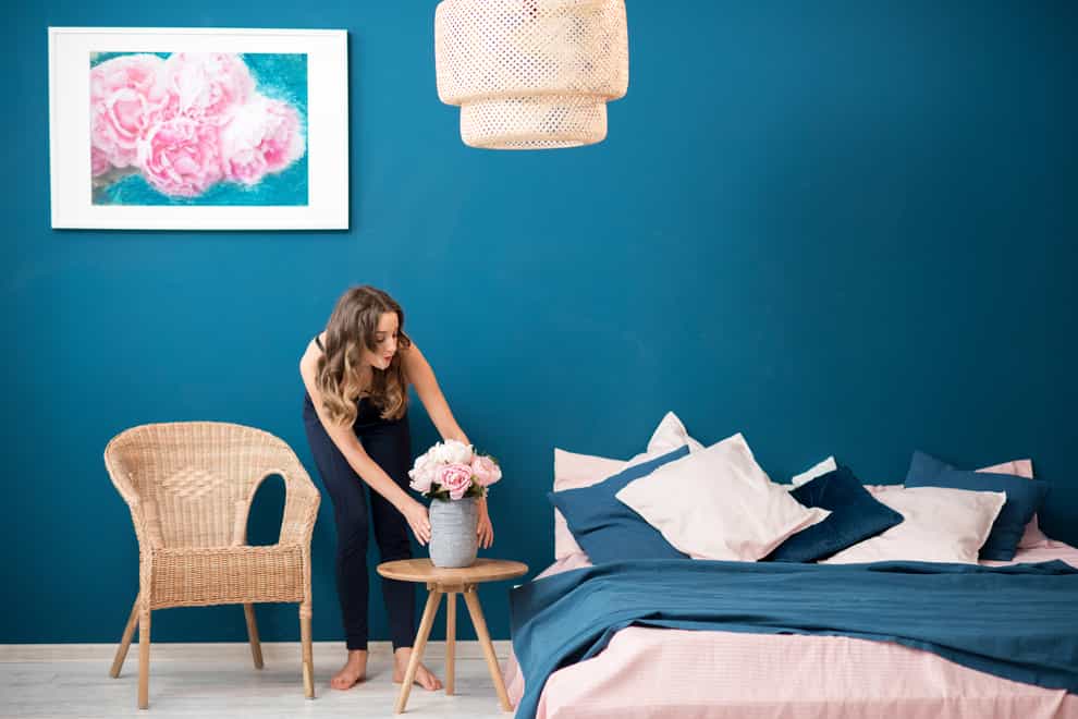 Woman arranging flowers in the bedroom