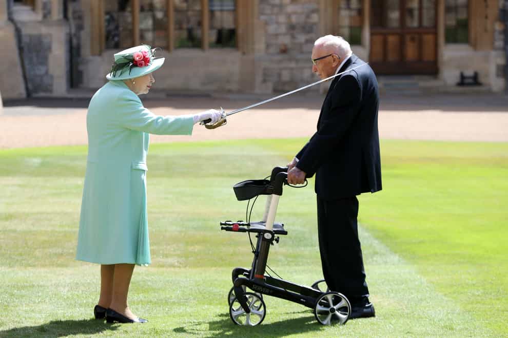 Captain Sir Tom Moore receiving his knighthood from the Queen