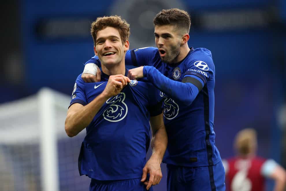 Christian Pulisic, right, celebrates with Marcos Alonso after teeing up his Chelsea team-mate's goal against Burnley