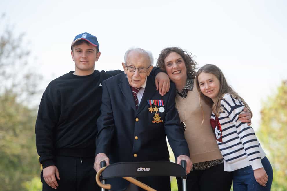 Captain Sir Tom Moore with, left to right, grandson Benji, daughter Hannah Ingram-Moore and granddaughter Georgia, at his home in Marston Moretaine, Bedfordshire