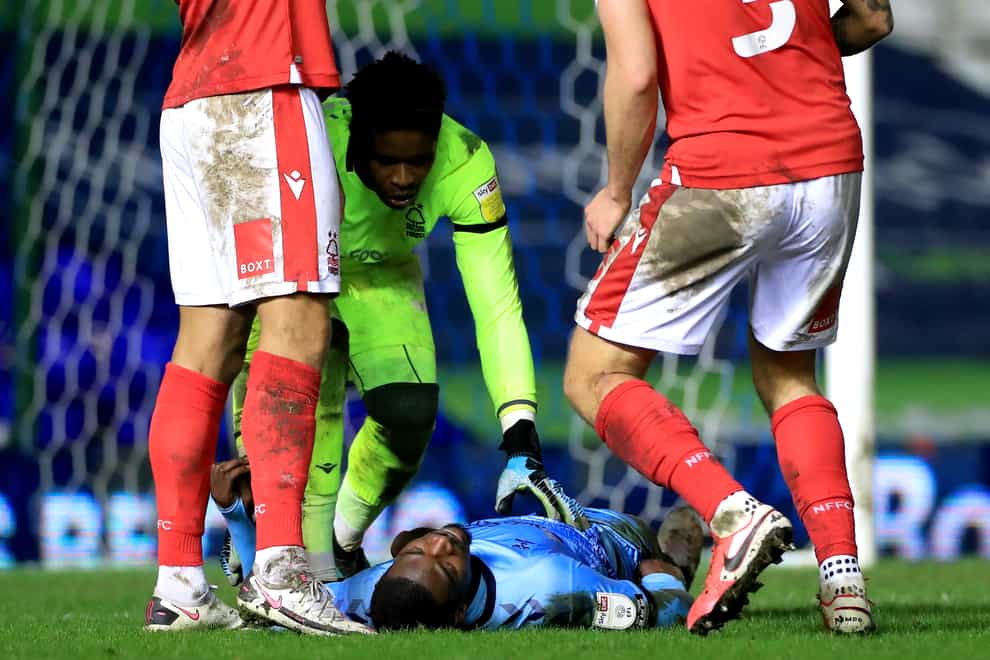 Coventry's Amadou Bakayoko lies injured on the pitch during the match against Nottingham Forest on Tuesday (Mike Egerton/PA).