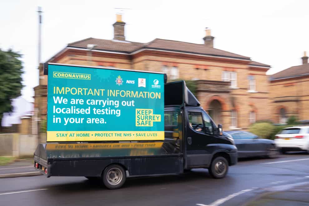 A mobile billboard announces door-to-door coronavirus testing in Woking, Surrey (Dominic Lipinski/PA)