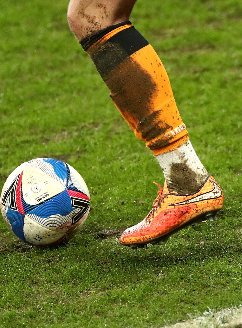 A general view of a football and a player's boots