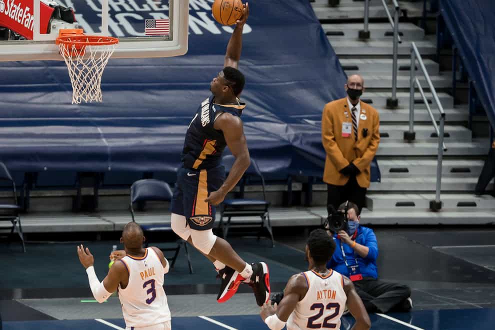 New Orleans Pelicans forward Zion Williamson (1) dunks past Phoenix Suns center Deandre Ayton (22) and guard Chris Paul (3)